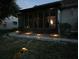 Night view of backyard with screened porch and landscape lighting at 13219 Greenview Ct, Hudson, FL 34669