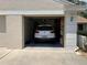 Attached garage with space for one car and storage shelves at 13219 Greenview Ct, Hudson, FL 34669