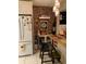 Kitchen with brick accent wall and breakfast bar at 13219 Greenview Ct, Hudson, FL 34669