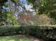 Landscaped backyard with crape myrtle tree and hedges at 13219 Greenview Ct, Hudson, FL 34669