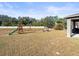 Spacious backyard with a playground and patio at 14143 Wake Robin Dr, Brooksville, FL 34604