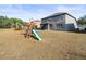Large backyard with a two-story home and playset at 14143 Wake Robin Dr, Brooksville, FL 34604