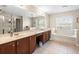 Spa-like bathroom with double sinks, tub, and shower at 14143 Wake Robin Dr, Brooksville, FL 34604