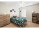 Bedroom with a twin bed, dresser, and toy shelf at 14143 Wake Robin Dr, Brooksville, FL 34604