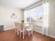 Bright breakfast nook with white table and chairs, adjacent to kitchen at 14143 Wake Robin Dr, Brooksville, FL 34604