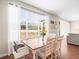 Bright dining area with wooden table and chairs, overlooking backyard at 14143 Wake Robin Dr, Brooksville, FL 34604