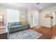 Light and airy entryway with a comfy couch and wood floors at 14143 Wake Robin Dr, Brooksville, FL 34604