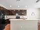 Modern kitchen with dark cabinetry, granite countertops, and stainless steel appliances at 14143 Wake Robin Dr, Brooksville, FL 34604