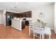 Modern kitchen with dark wood cabinets and a breakfast bar at 14143 Wake Robin Dr, Brooksville, FL 34604