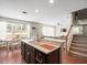 Modern kitchen with island, breakfast bar, and view to dining area at 14143 Wake Robin Dr, Brooksville, FL 34604