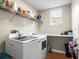 Laundry room with washer, dryer, and shelving at 14143 Wake Robin Dr, Brooksville, FL 34604