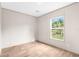 Simple bedroom featuring wood-look floors and a window at 18077 Evening Star Ave, Brooksville, FL 34604