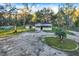House with a gravel driveway and lush green lawn at 21000 Nina Ln, Brooksville, FL 34601