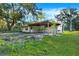 Home features a covered patio with picnic table in the backyard at 21000 Nina Ln, Brooksville, FL 34601