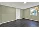 Light green bedroom with dark gray tile flooring and a double door closet at 21000 Nina Ln, Brooksville, FL 34601