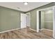 Bedroom with wood-look flooring, and closet with bi-fold doors at 21000 Nina Ln, Brooksville, FL 34601