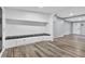 Open entryway with built-in bench seating and wood-look floors at 21000 Nina Ln, Brooksville, FL 34601