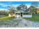 Quaint one-story house with a covered porch and large backyard at 21000 Nina Ln, Brooksville, FL 34601