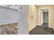 Gray and beige hallway with wood-look flooring and access to other rooms at 21000 Nina Ln, Brooksville, FL 34601