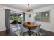 Dining room with wood table and gray chairs, near sliding doors at 2413 Hazelwood Ln, Clearwater, FL 33763