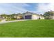 Large grassy backyard with a view of the house and neighborhood at 262 Hartford Ct, Spring Hill, FL 34609