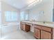 Bathroom boasts double sinks, a soaking tub, and a separate shower at 262 Hartford Ct, Spring Hill, FL 34609
