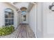 Front entry with a white door and stone pathway at 262 Hartford Ct, Spring Hill, FL 34609