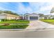 Tan one-story house with a two-car garage and nicely landscaped yard at 262 Hartford Ct, Spring Hill, FL 34609