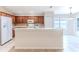 Kitchen features wood cabinets, white appliances, and breakfast bar at 262 Hartford Ct, Spring Hill, FL 34609