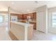 Galley kitchen with wood cabinets and breakfast bar at 262 Hartford Ct, Spring Hill, FL 34609