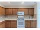 Kitchen features wood cabinets and white appliances at 262 Hartford Ct, Spring Hill, FL 34609
