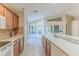 Kitchen with wood cabinets, white appliances, and breakfast bar at 262 Hartford Ct, Spring Hill, FL 34609