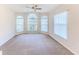Living room with bay windows, ceiling fan and neutral carpeting at 262 Hartford Ct, Spring Hill, FL 34609