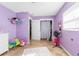 Charming bedroom with purple walls and playful decor at 27329 Azen Loop, Brooksville, FL 34602