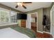 Bright bedroom with hardwood floors, large windows and view into living room at 29703 69Th N St, Clearwater, FL 33761