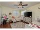 Bedroom with two beds, a dresser, and a large TV at 29703 69Th N St, Clearwater, FL 33761