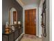 Entryway with a wooden door, mirror, and console table at 29703 69Th N St, Clearwater, FL 33761