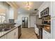 Well-equipped kitchen with stainless steel appliances and white cabinets at 29703 69Th N St, Clearwater, FL 33761