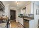 Modern kitchen with white cabinets, granite counters, and stainless steel appliances at 29703 69Th N St, Clearwater, FL 33761