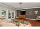 Living area with sectional sofa, hardwood floors, and TV at 29703 69Th N St, Clearwater, FL 33761