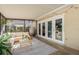 Screened porch with seating area and access to backyard at 29703 69Th N St, Clearwater, FL 33761