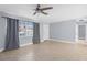 Living room with tile floors, ceiling fan, and gray walls at 3131 Deltona Blvd, Spring Hill, FL 34606