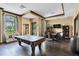Inviting game room with a pool table, seating area, and a flat screen television at 3312 Francoa Dr, Odessa, FL 33556