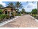 A guard house and gated entrance featuring lush landscaping on a brick road at 3312 Francoa Dr, Odessa, FL 33556