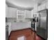Bright kitchen features white cabinets, stainless steel appliances, and hardwood floors at 3312 Francoa Dr, Odessa, FL 33556