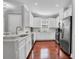Modern kitchen featuring white cabinets, stainless steel appliances, and hardwood floors at 3312 Francoa Dr, Odessa, FL 33556