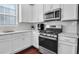 Modern kitchen features white cabinets, stainless steel appliances, and hardwood floors at 3312 Francoa Dr, Odessa, FL 33556