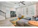 Living room with sectional sofa, area rug, and view into the kitchen at 3481 Bumelia Ln, New Port Richey, FL 34655