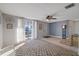 Living room with tiled floors, ceiling fan, and an accent wall at 4151 Hillsdale Dr, New Port Richey, FL 34652