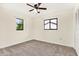 Spacious bedroom featuring ceiling fan and two windows at 5461 Colchester Ave, Spring Hill, FL 34608